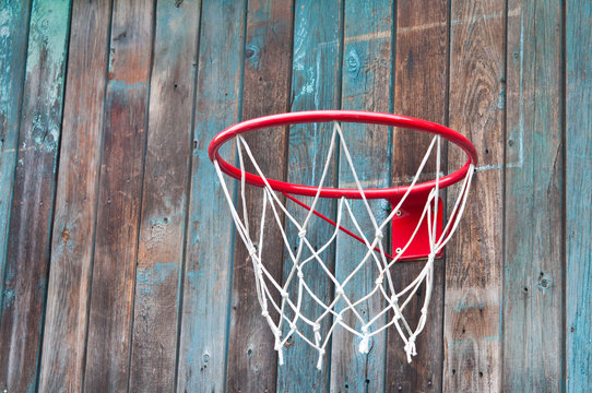 Basketball net on an old wooden wall.