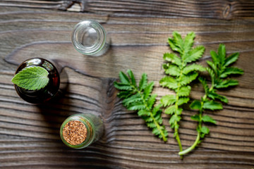 Alternative medicine. Store up medicinal herbs. Herbs in glass on wooden table background