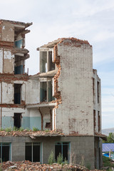 The old destroyed brick multi-storey building