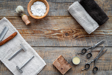 Barbershop. Men's shaving and haircut. Brush, razor, foam, sciccors on wooden table background top view copyspace