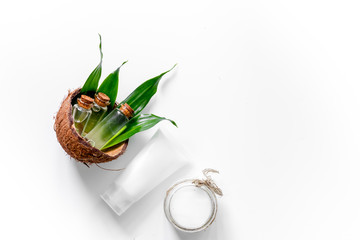 Coconut oil and cream on white background top view copyspace