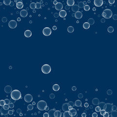 Random soap bubbles. Scattered border with random soap bubbles on deep blue background. Vector illustration.