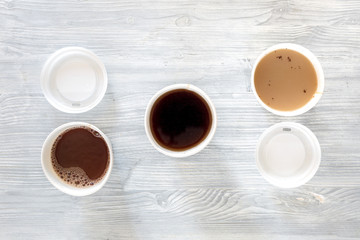 Coffee to go. Coffee cups with cover on wooden table backound top view