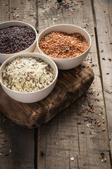 collection of different varieties of rice on wooden rustic background