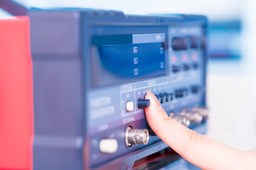 woman presses a button on an electronic measuring instrument
