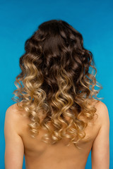 Woman with Long Healthy Colorful Ombre Wavy Hair. Close Up of Hairstyle