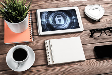 Web security and technology concept with tablet pc on wooden tab