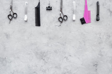 Hairdresser workplace. Combs and sciccors on grey table background top view copyspace
