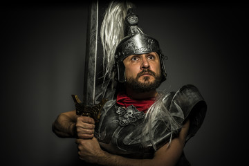 Legionnaire, Roman centurion with armor and helmet with white chalk, steel sword and long red cape