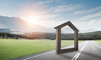 Conceptual background image of concrete home sign on asphalt road