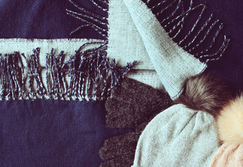 Winter background with blue scarf, pink hat and gloves