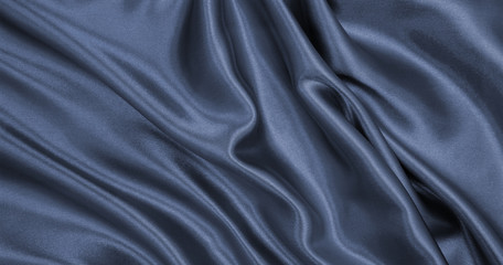 Smooth elegant dark grey silk or satin texture as abstract background. Luxurious background design