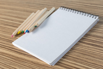 Color pencil and sketchbook on a table