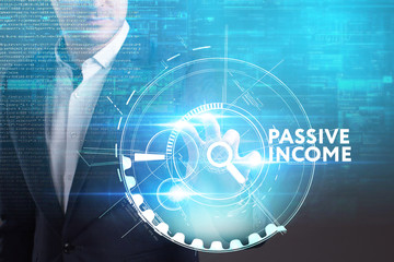 Business, Technology, Internet and network concept. Young businessman working on a virtual screen of the future and sees the inscription: Passive income