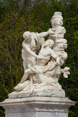 Versailles, France - April 13, 2014: Marble statue in the park of Palace of Versailles, France