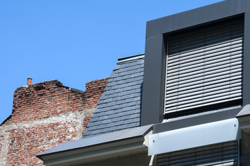 Contemporary and vintage roofs closeup in modern urban environment