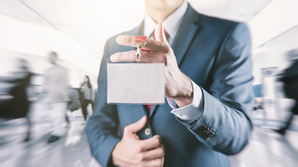 Businessman holding a exhibition identity name card