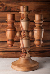 wooden candlestick. for the three candles. wooden background
