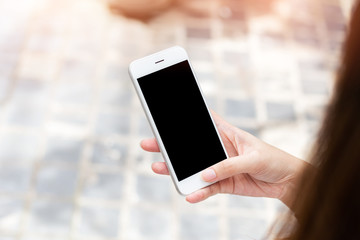 Close up young woman hands holding mobile smart phone isolated black screen for advertising display or mock up design