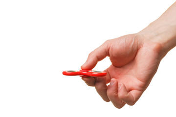 Male hand holding a red fidget spinner isolated on white background