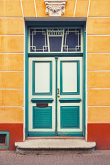 Fototapeta na wymiar Old beautiful green wooden door in the old town of Tallinn