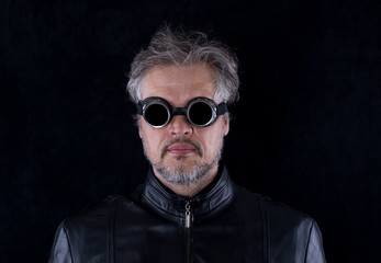 Portrait of a man in motorcycle goggles on a black background