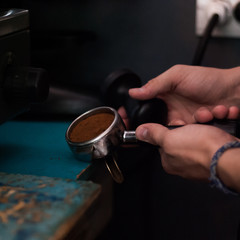 Fototapeta na wymiar A man is making coffee in a coffee machine