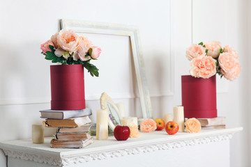  Artificial peonies in a box. Decor on the fireplace