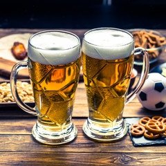 Appetizers and beer on the table for watch the football match.