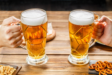 Appetizers and beer on the table for watch the football match.