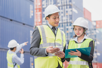 Secretary and businessman in logistic, export, import industry with shipping cargo container freight in background