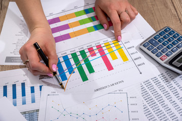 financial statistics concept - businesswoman analytics financial accounting market chart or diagram.