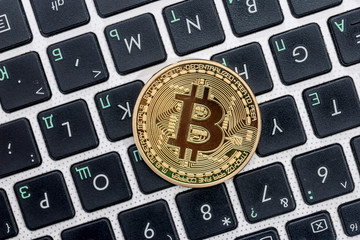 new currency - bitcoin on white laptop keyboard