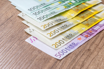 100 200 500 euro banknote on wooden desk