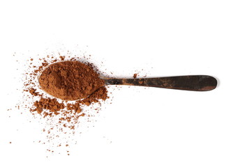 pile cocoa powder with metal spoon isolated on white background