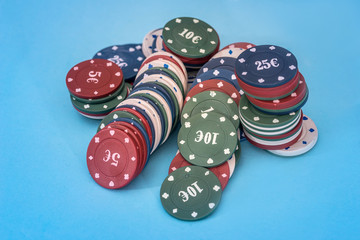 Many poker chips isolated on blue background