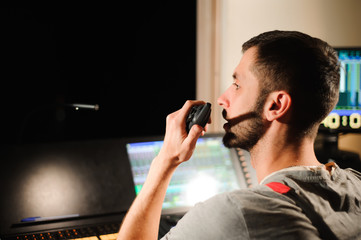 A lighting engineer works with lights technicians control on the concert show. Professional light...