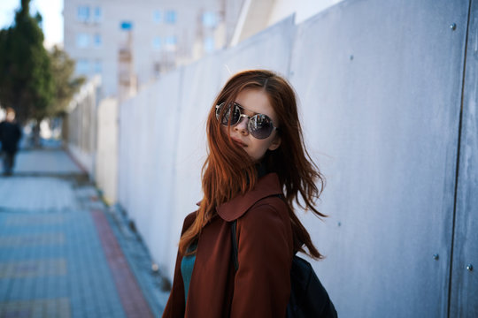 Young beautiful woman in sunglasses outdoors in the city