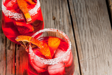 Refreshing summer drinks. Cocktail bloody orange margarita, in glasses on a wooden rustic table...