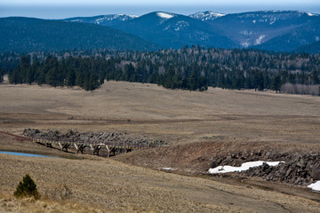 Snow still clings to the high mountains and shaded areas near the Railroad Grade Trail in Arizona's White Mountains near Greer.