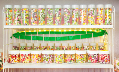 Different sweets in jars at candy shop