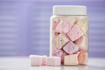 Tasty marshmallow in jar at candy shop