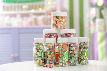 Different candies in jars at shop