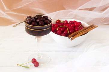 Glass with homemade Cherry Jam on wooden background