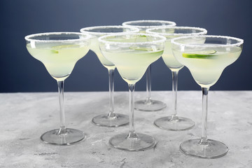 Delicious cocktail with tequila and lime on table