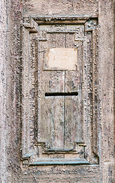 Vintage mail slot in a wooden door