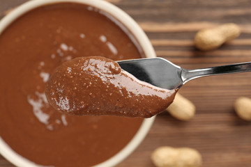 Shovel with creamy peanut butter, closeup