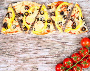 Horizontal food banner with pieces of homemade pizza red cherry tomatoes on wooden background. Empty space for text.
