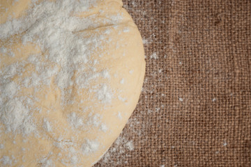 Ball of dough for pizza on the background of rustic