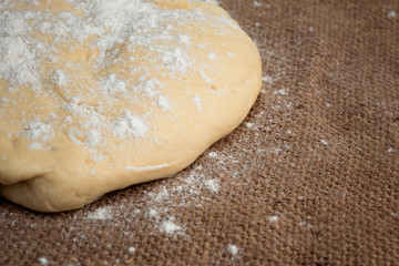Ball of dough for pizza on the background of rustic